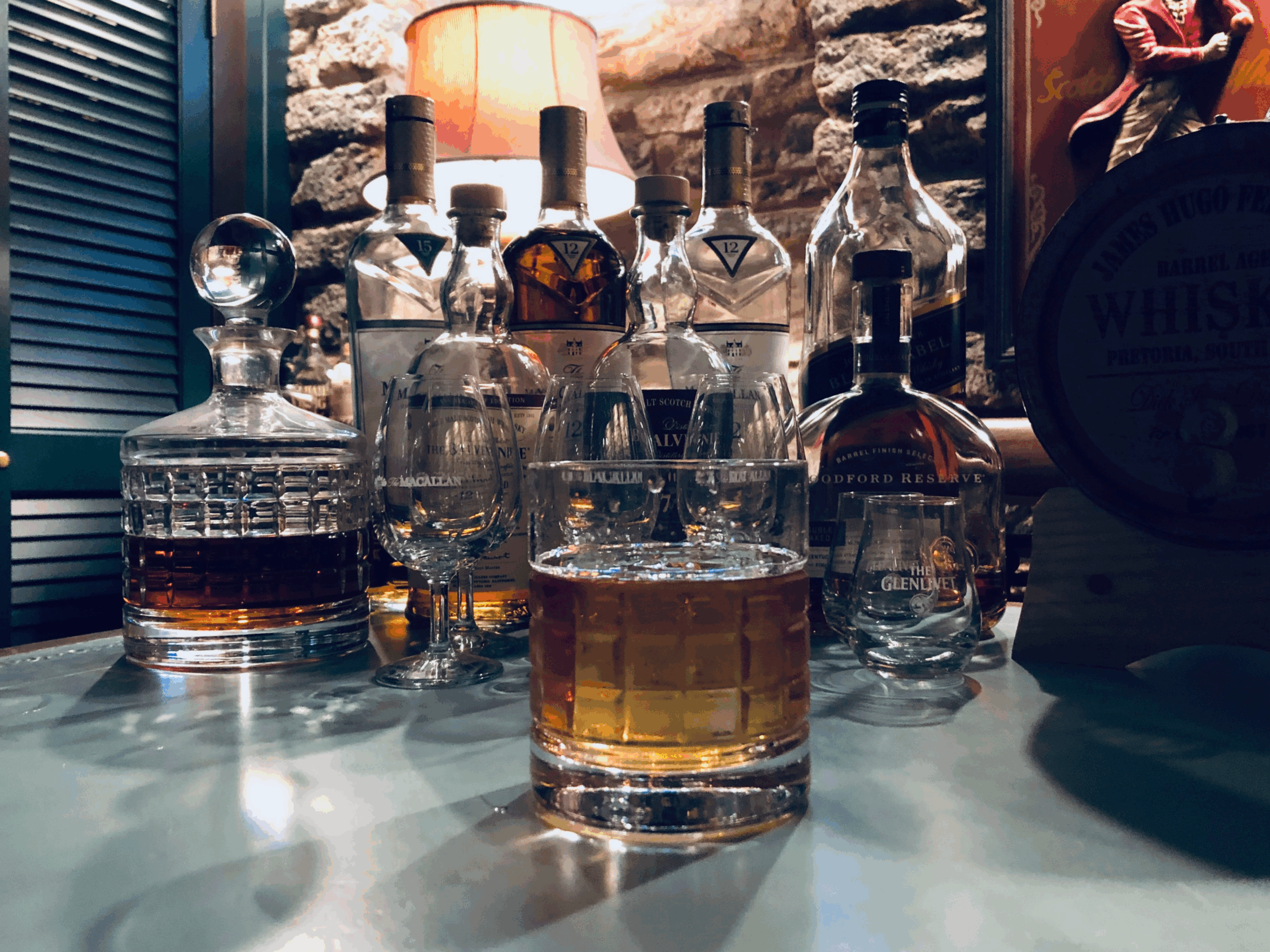 BIG ICE Basement 3 Liquor bottles, empty glasses, and a bourbon with a BIG ICE cube in the basement where BIG ICE got started.